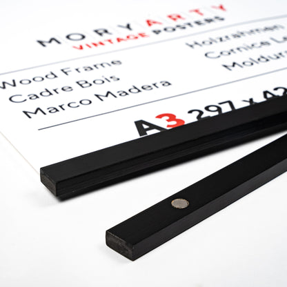 Black Pine magnetic wood frame with two sleek wooden bars and a simple rope for hanging, displaying a poster on a wall in a modern, elegant setting, back corner closeup picture