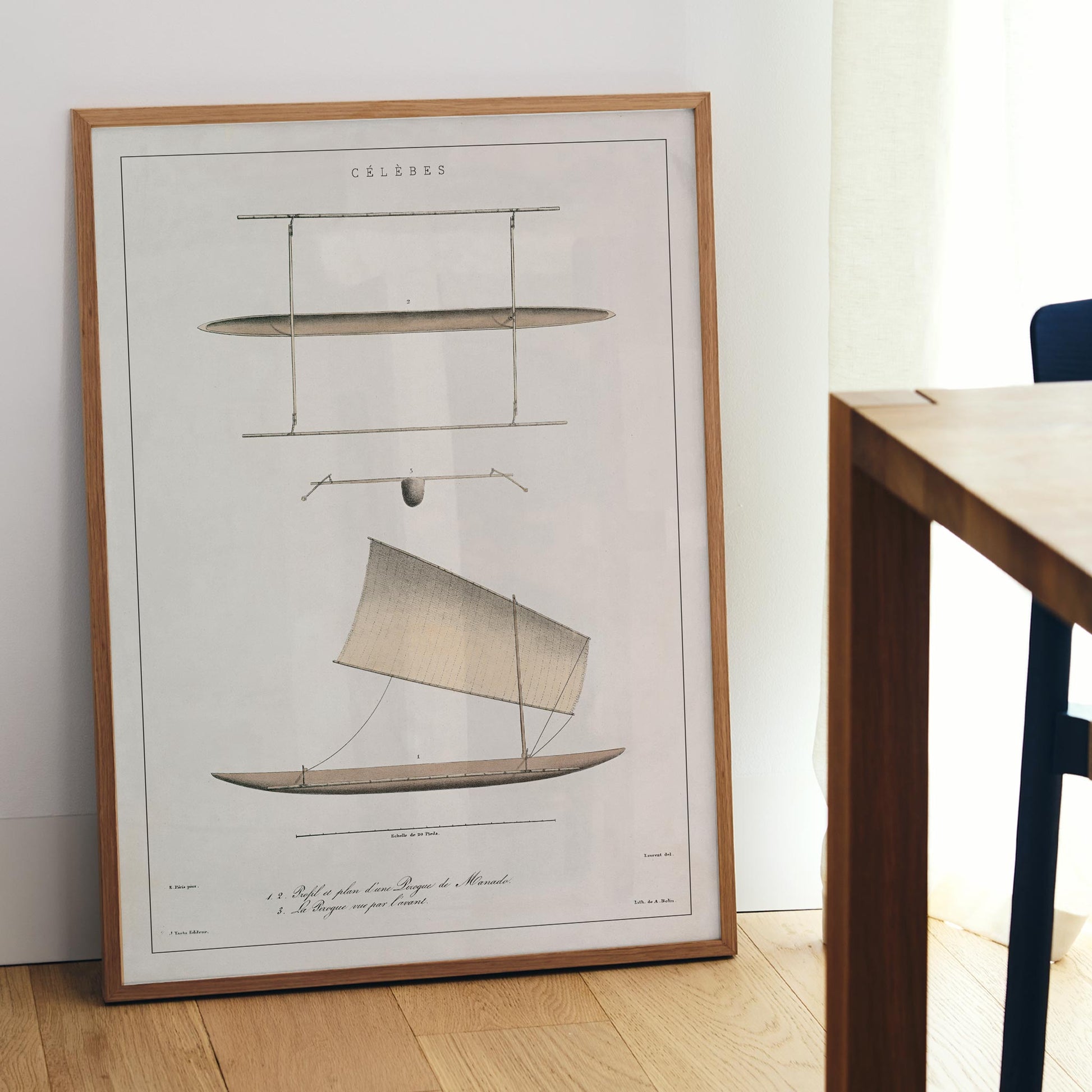J. Tastu Celebes Canoe poster with minimalist canoe plan and side view in soft beige tones, framed and displayed in modern living room decor