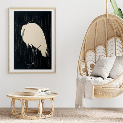White egret standing in the rain art print poster with dark background by Ohara Koson, framed and displayed in home decor