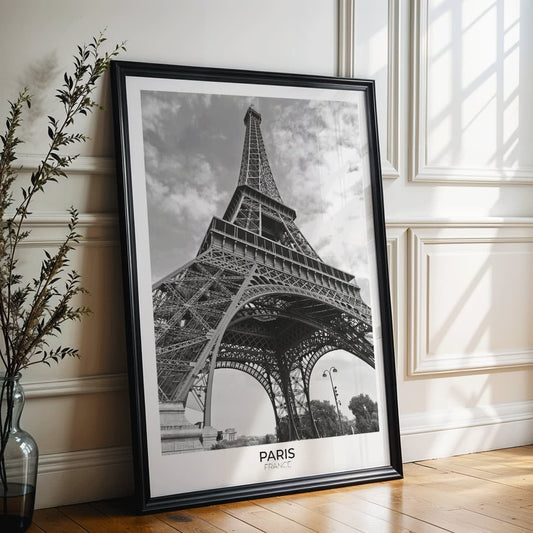 Black and white picture of the Eiffel Tower in Paris featuring its intricate structure by artist poster titled Tour Eiffel Black and White, framed and displayed in home decor