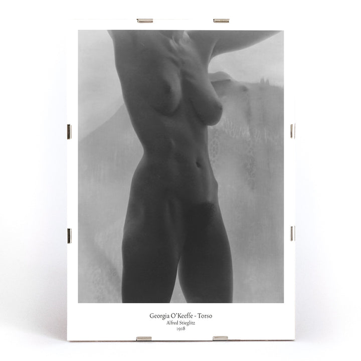 Black and white artistic nude torso photograph of Georgia O Keeffe titled Torso by Alfred Stieglitz poster, framed and displayed in modern living room decor