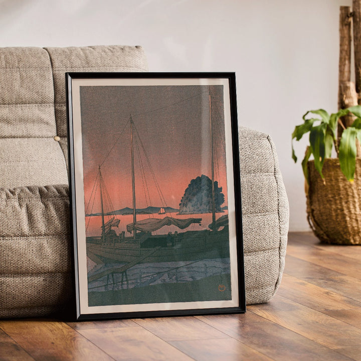 Ukiyo e Harbour Sunset by Kawase Hasui with boats docked at sunset tranquil evening sky island and mountains in background, framed and displayed in home decor