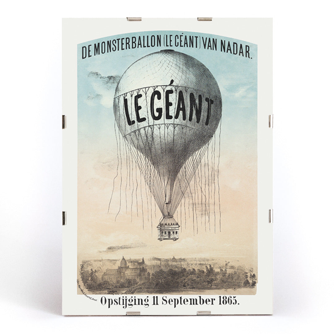Hot air balloon Le Géant by Nadar Morriën and Amand flying above a cityscape poster titled The Monster Balloon, framed and displayed in modern living room decor