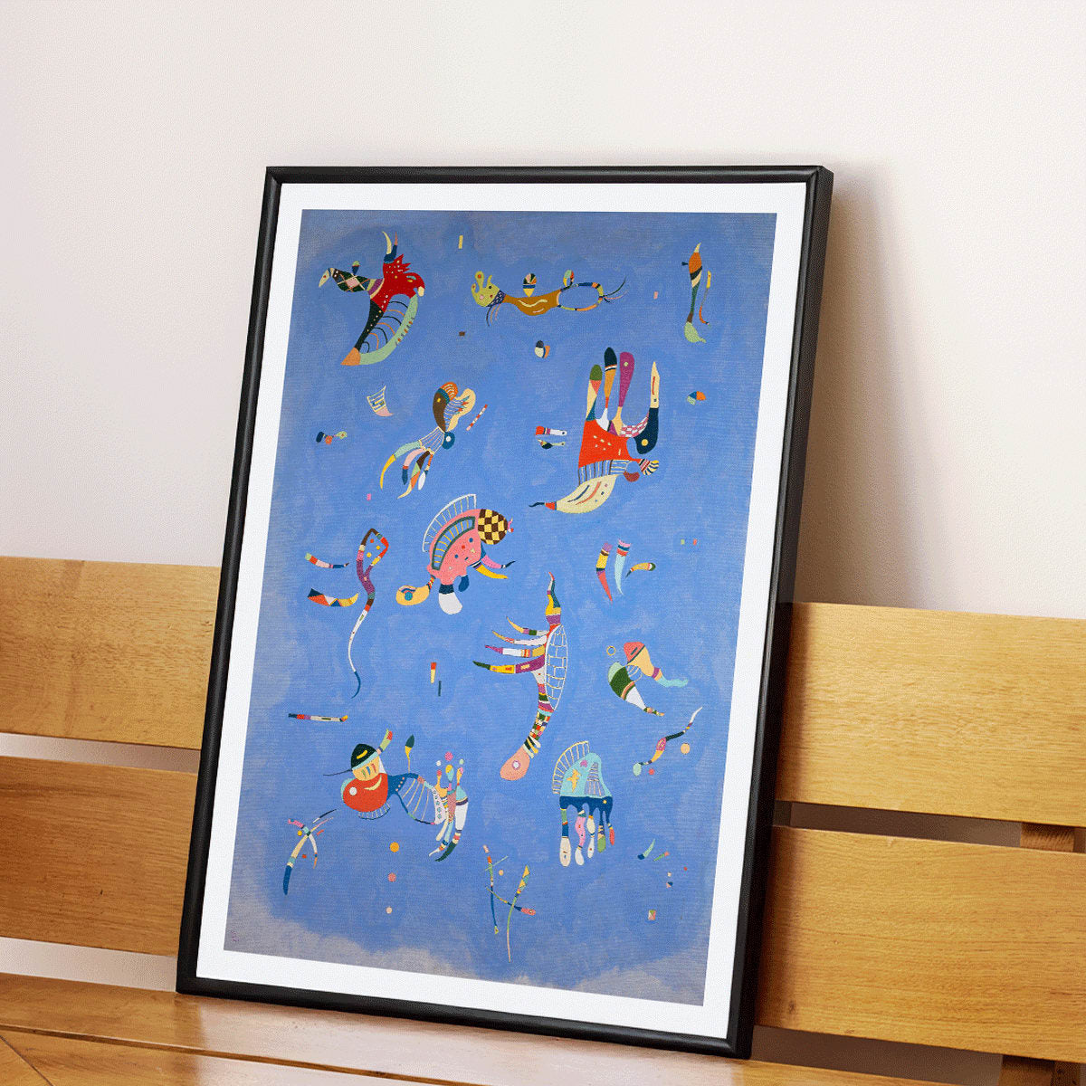 Bleu de Ciel by Wassily Kandinsky abstract blue artwork poster with colorful geometric shapes and vibrant colors on a blue background, framed and displayed in home decor