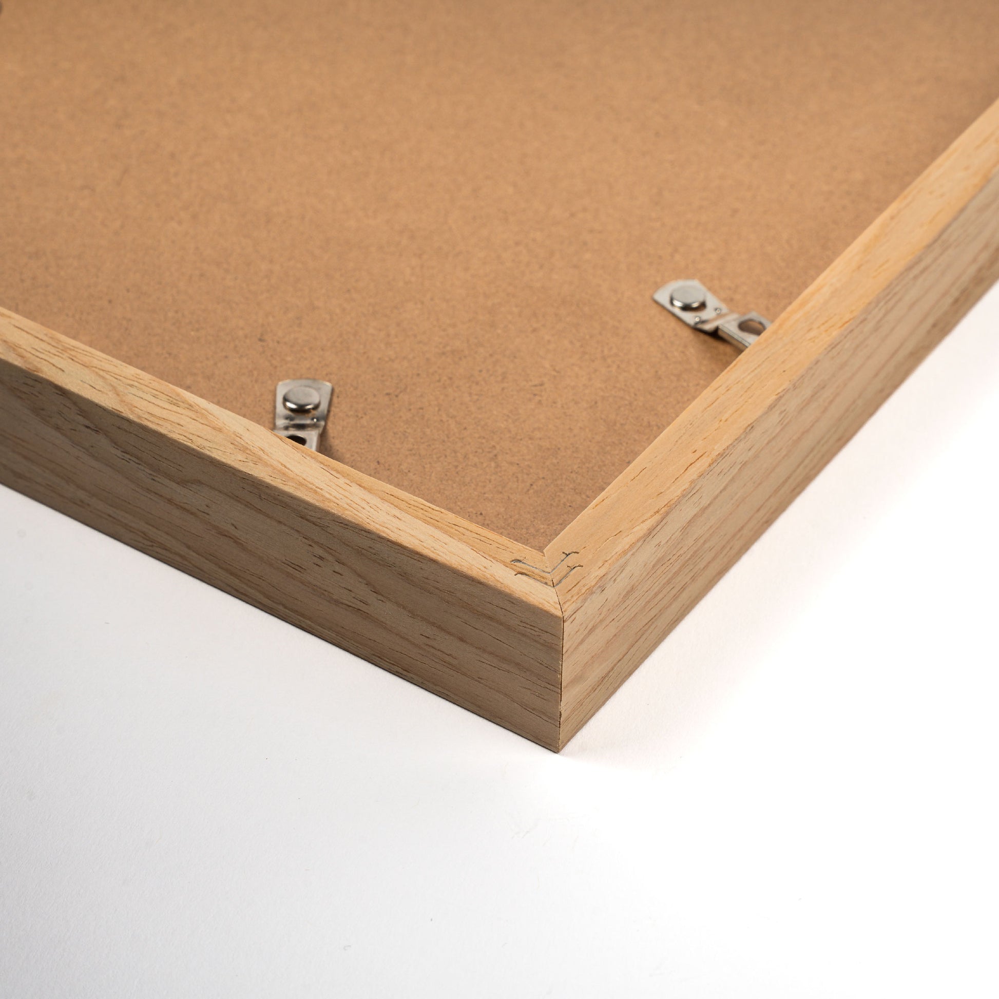 Light pine wood frame with a natural finish, displaying a photo or artwork, classic and elegant design suitable for modern or traditional interiors, back corner closeup picture