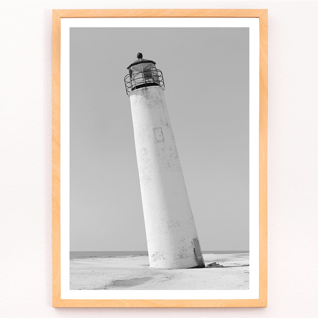 Cape Saint George Lighthouse poster featuring a tilted lighthouse on a sandy beach in Apalachicola Franklin County Florida, framed and displayed in modern living room decor