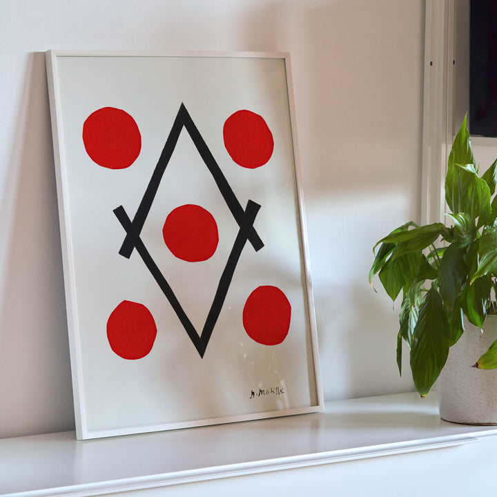 Henri Matisse Losange poster with five red circles around intersecting black lines forming a diamond on white ground, framed and displayed in modern living room decor