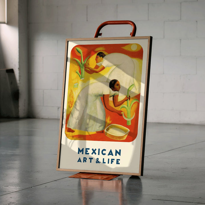 Diego Rivera painting of two women in white dresses harvesting crops in a vibrant orange and yellow field Mexican Art and Life magazine cover poster, framed and displayed in modern living room decor