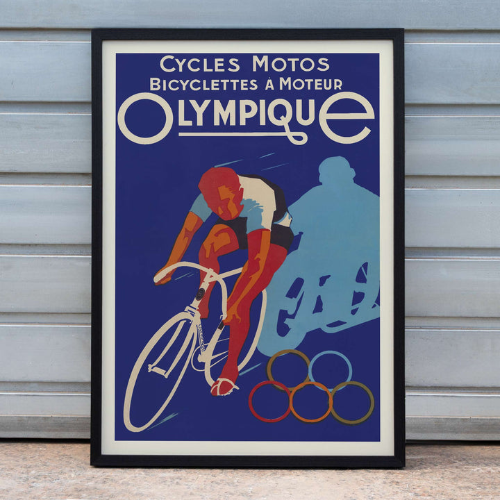 Affiches Gaillard Cycles olympique poster featuring a racing cyclist, bold lettering, blue background, and Olympic rings in vintage style, framed and displayed in home decor