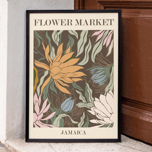 Colorful botanical poster by Moryarty featuring vibrant tropical flowers and leaves titled Flower Market Jamaica, framed and displayed in home decor