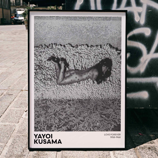 Yayoi Kusama black and white artwork featuring a dotted figure and a woman with polka dots on a textured background poster, framed and displayed in home decor