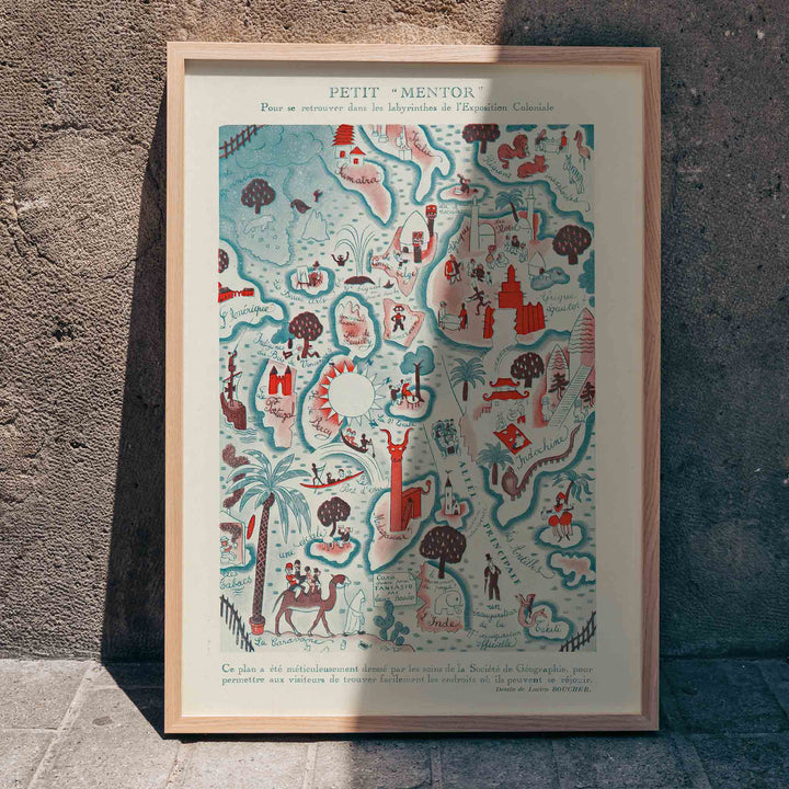 Colorful illustrated map poster Petit Mentor Carte de l exposition coloniale by Lucien Boucher featuring various regions and activities, framed and displayed in home decor