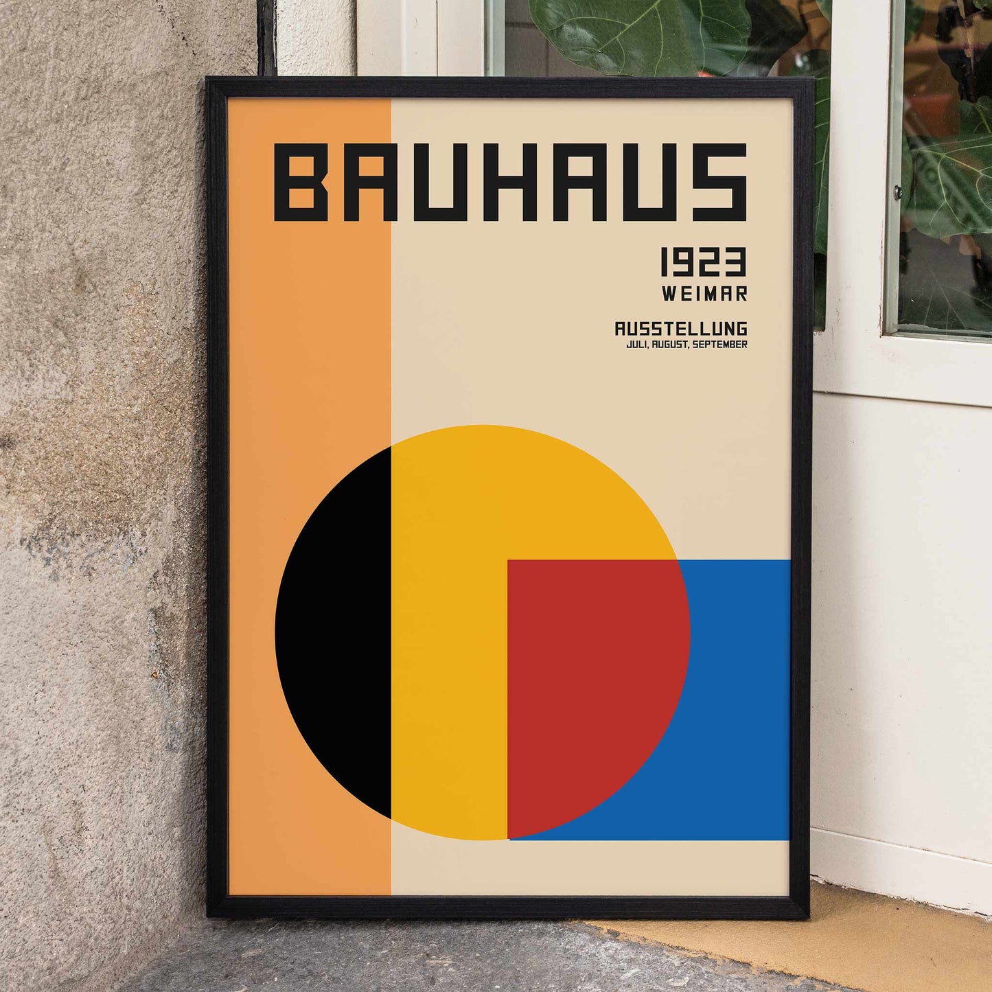 Bauhaus Poster 1 inspired by the Weimar Exhibition featuring geometric shapes in warm bold colors and modernist design style, framed and displayed in home decor