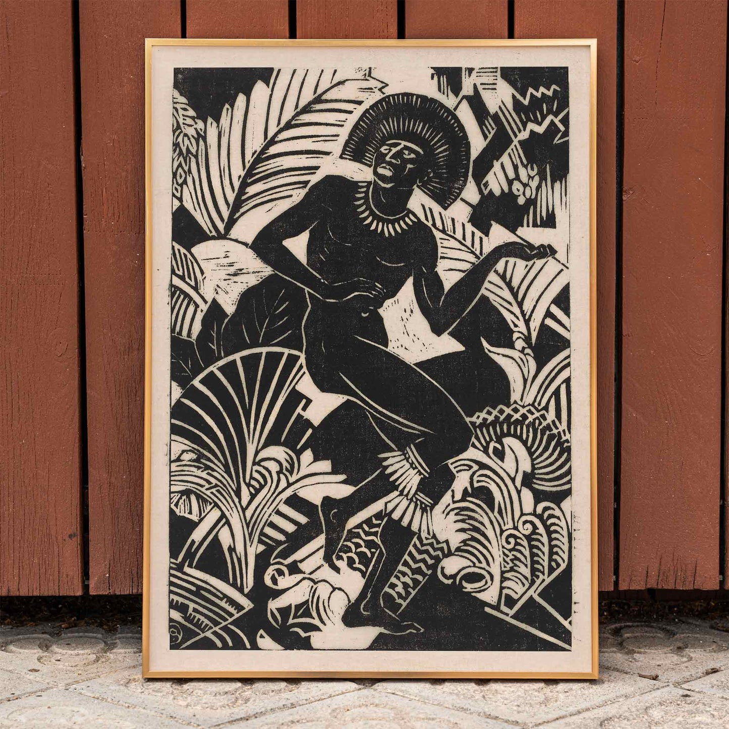 Black and white artwork and poster of a stylized dancing figure among bold jungle plants by Henri van der Stok Jager, framed and displayed in home decor