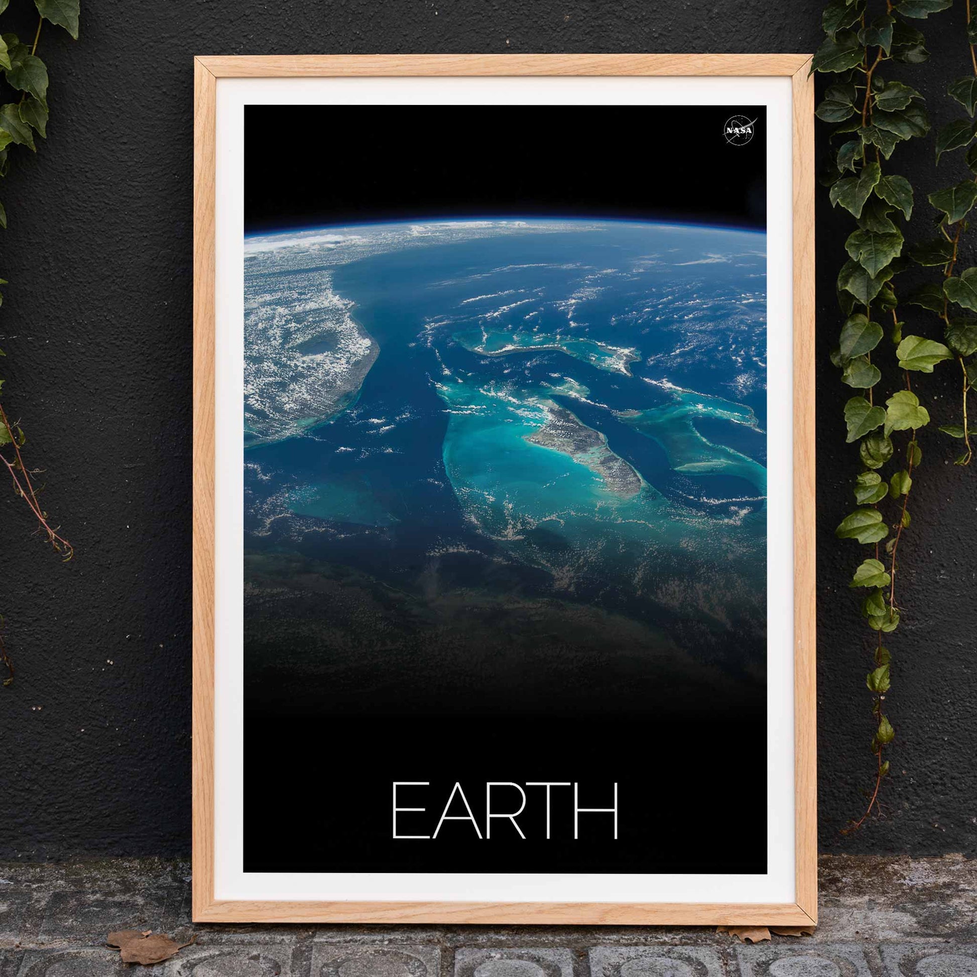 Earth from Space 2 by NASA showing a stunning satellite image of blue oceans continents and clouds, framed and displayed in home decor
