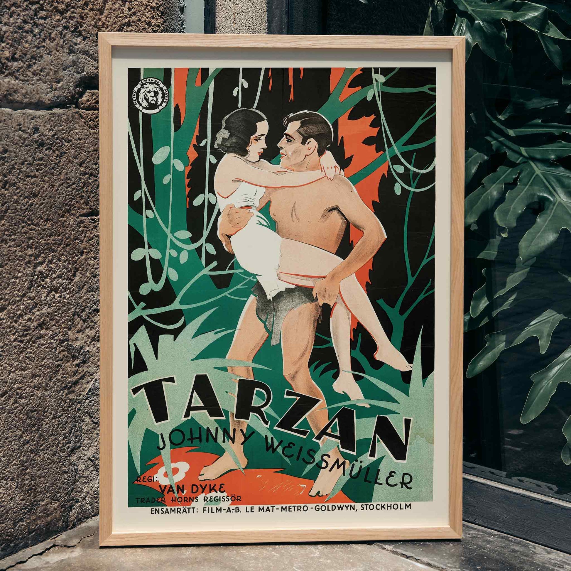 Tarzan the Ape Man by Eric Rohman classic movie poster featuring a jungle scene with Tarzan carrying a woman and other characters, framed and displayed in home decor