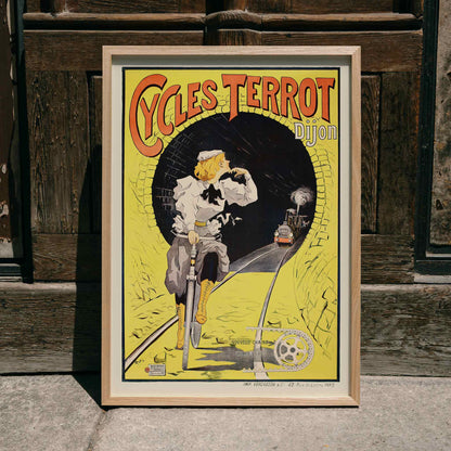 Vintage poster of a woman riding a bicycle in a tunnel with a train approaching Cycles Terrot Dijon artwork, framed and displayed in home decor