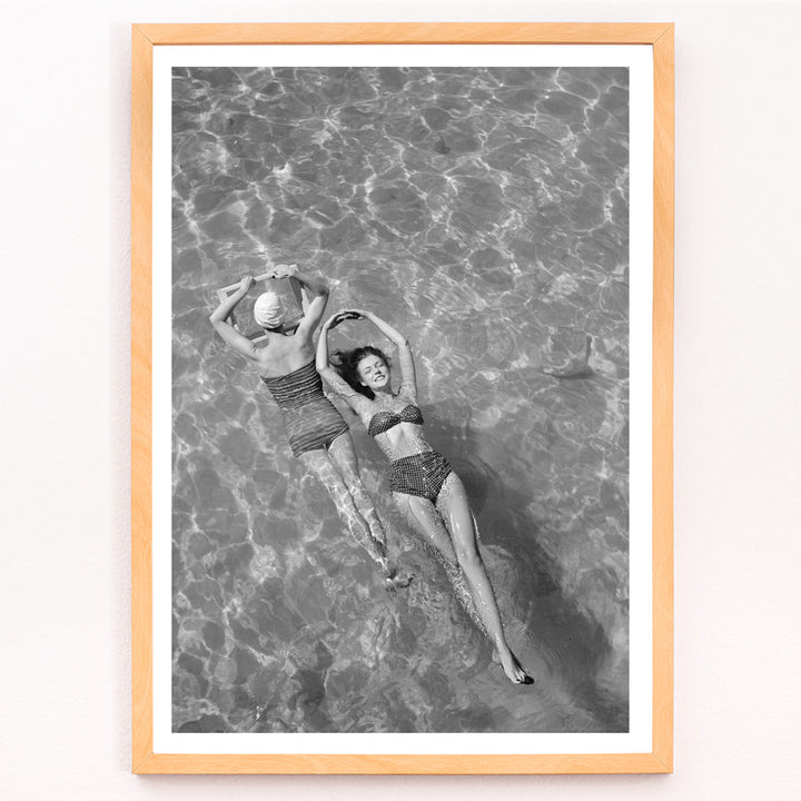 Closeup detail of Fashion models in vintage bathing suits floating in a swimming pool artwork by Toni Frissell