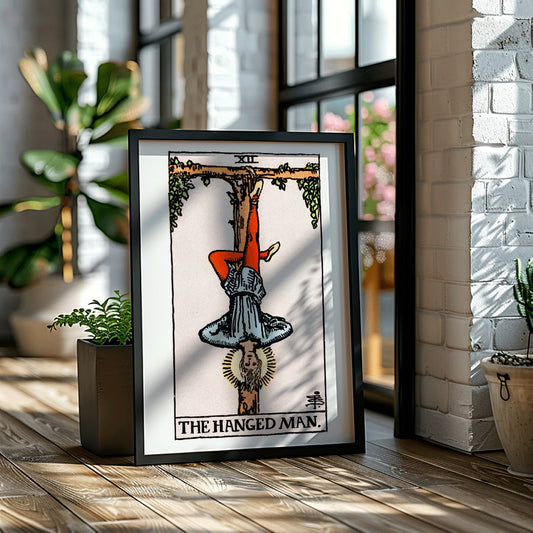 Hanged Man Tarot Card by Rider Waite, figure hanging upside down from wooden structure, mystical poster art, framed and displayed in home decor