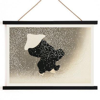 Poster of Tomoe no yuki by Kamisaka Sekka showing a snowy scene with a silhouette of a figure in dark attire under heavy snowfall wearing a white hat and holding a walking stick, with wooden magnetic frame on white background