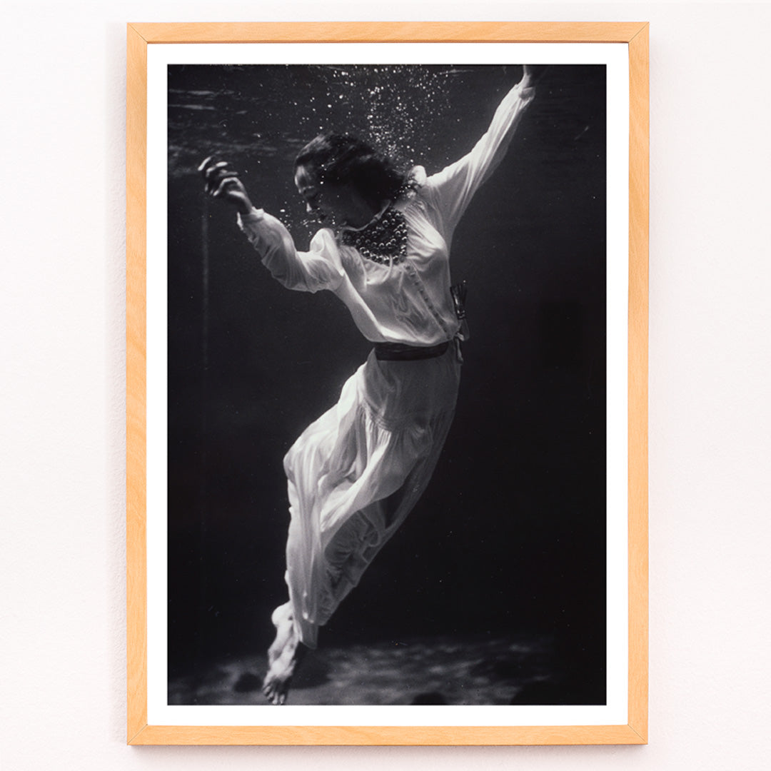 Closeup detail of Black and white artwork of a fashion model floating underwater in dolphin tank Marineland Florida by Toni Frissell