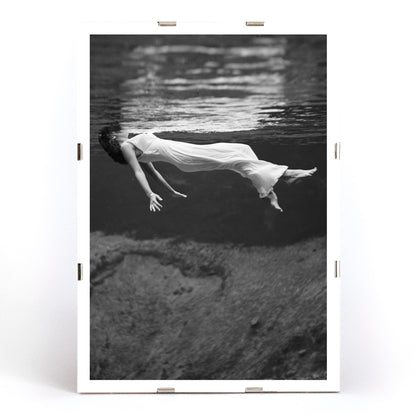 Underwater woman in white flowing dress at Weeki Wachee spring Florida by Toni Frissell, framed and displayed in modern living room decor