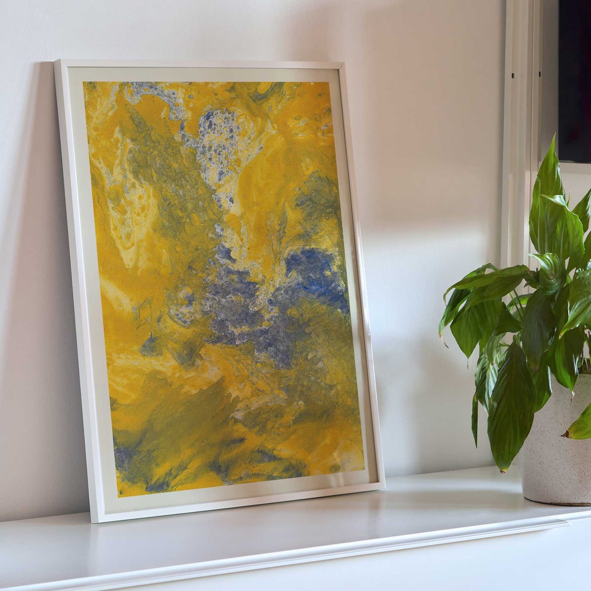 Margarete Rumpf Yellow marbled paper poster with swirling ochre, cream and blue-grey abstract textures, framed and displayed in modern living room decor
